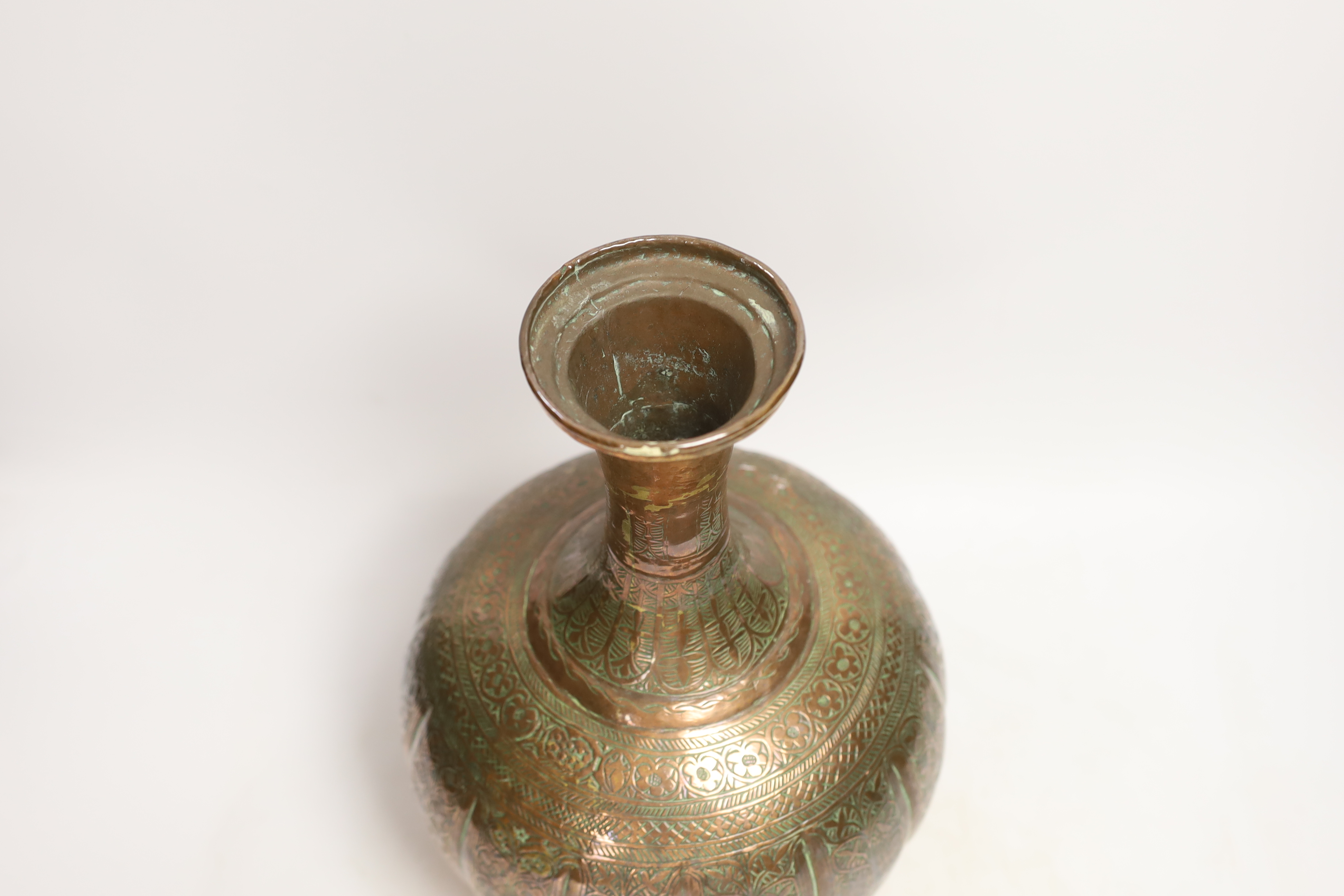 An Islamic engraved copper vase, 31cm